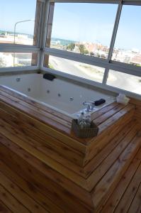 a bath tub in a room with a window at Complejo Bahia Ballenas in Rawson +8 photos