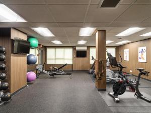 a gym with exercise bikes and a flat screen tv at BEST WESTERN PLUS Carlton Plaza Hotel in Victoria