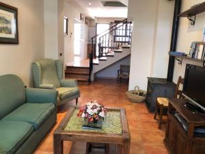 a living room with two couches and a coffee table at La casa de Tita Elvira 2 in Zafarraya