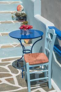 
a table with chairs and a vase with flowers on it at Galazia Studios in Naxos Chora
