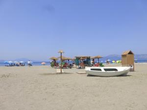 a boat sitting on a beach with a lifeguard shack at Papadioti Apartments in Pefki