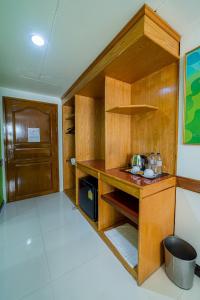 a kitchen with a wooden desk with a microwave at The Holidays Hill betong in Betong
