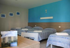 Katil atau katil-katil dalam bilik di Serafico Guesthouse