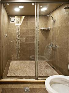 a bathroom with a shower and a toilet at Shanhai Guan B&B in Ruifang +78 photos