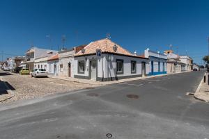 a street with houses on the side of a road at Casa Carolina in Vila Real de Santo António