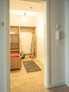 a room with a bed and a closet at Nadmorskie Tarasy A 406 in Kołobrzeg +14 photos