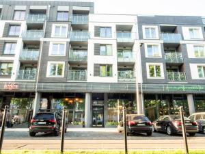 a building with cars parked in front of it at Nadmorskie Tarasy A 406 in Kołobrzeg