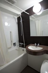 a bathroom with a sink, toilet and bathtub at Ueno Touganeya Hotel in Tokyo
