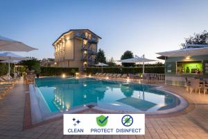 a pool at a hotel with a sign that says clean project district at Hotel Villa Tiziana in Marina di Massa