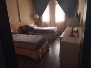 Cama ou camas em um quarto em Meral Hotel