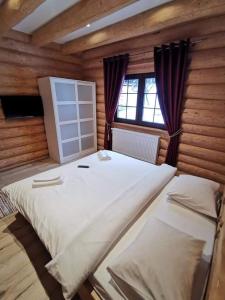 Ένα ή περισσότερα κρεβάτια σε δωμάτιο στο Cabana Livada