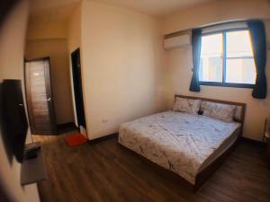 Postel nebo postele na pokoji v ubytování Jieyuan Homestay