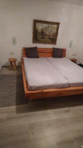 a large wooden bed in a room with at Ferienwohnung Alpina Inzell in Inzell
