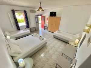 a large room with two beds and a couch at Anna Studios in Katapola