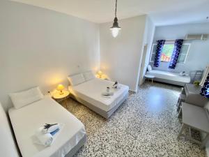 a small room with two beds and a bathroom at Anna Studios in Katapola