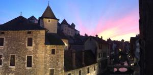 a view of an old castle at sunset at L'Appart' du 10 - T3 4 downtown Annecy with canal view in Annecy