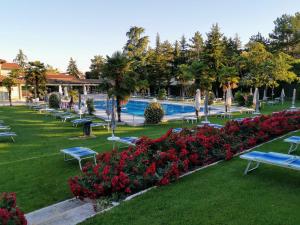 ośrodek z basenem, rzędem krzeseł i kwiatów w obiekcie Best Western Plus Hotel Modena Resort w mieście Formigine