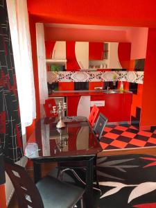 a dining room with a table and a kitchen at Casa Nicoli in Băile Olăneşti