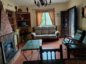 a living room with a couch and a fireplace at Cortijo la Joya in Cómpeta