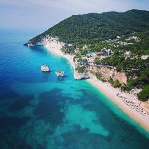 an aerial view of a beach with boats in the water at Hotel Il Melograno in Mattinata