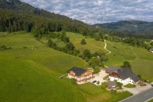 an aerial view of a house in a green field at Fumerhof in Strobl