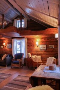 a living room with wooden walls and wooden ceilings at Å Rorbuer - by Classic Norway Hotels in Å