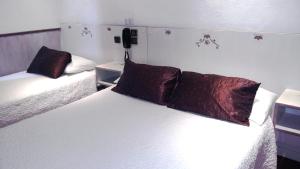 Letto o letti in una camera di Hotel Mignon