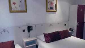Letto o letti in una camera di Hotel Mignon