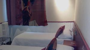 Letto o letti in una camera di Hotel Mignon