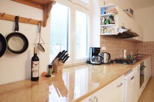 a kitchen with a counter with a bottle of wine on it at Maxova Bouda in Josefŭv Dŭl