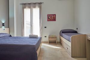 Katil atau katil-katil dalam bilik di B&B Bouganville House - casa vacanze