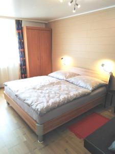 a bedroom with a bed with two lamps on it at Ferienwohnung Nagy in Innsbruck