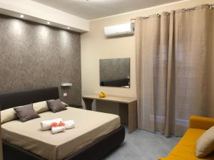 a bedroom with a bed and a television in it at Apartments " Le Ginestre" in Acireale