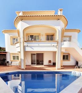 a villa with a swimming pool and a house at Villa Patri in Benissa