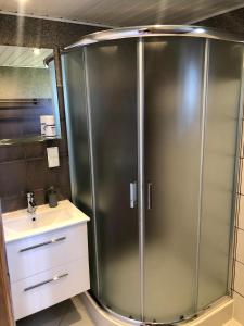 a stainless steel shower in a bathroom with a sink at Baltic Star in Władysławowo +78 photos