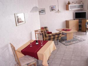 a living room with a table and a dining room at Haus am Fürstenweg in Neustadt an der Weinstraße