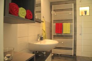 a bathroom with a sink and a towel rack at Ferienwohnung Haus Felix in Bad Elster