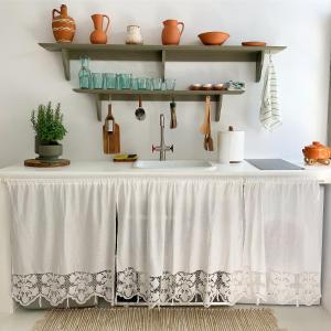 eine Küche mit einem Tisch und einem Tischtuch darauf in der Unterkunft Serifos Olive in Serifos Chora