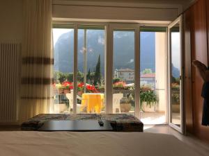 a bedroom with a bed and a view of a balcony at Eagle Rooms in Riva del Garda