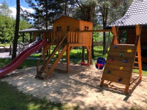 a playground with a slide and a play structure at Roztoczańskie Zacisze in Kaczórki