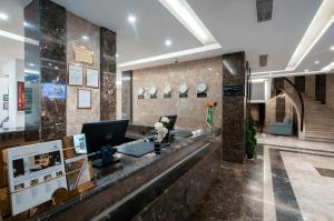 a lobby with a reception desk in a building at Bayat Suites in Muhayil