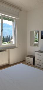 a bedroom with a large bed and a window at Eagle Rooms in Riva del Garda