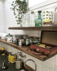 a kitchen with a sink and a shelf with dishes at Guest House CorteMazzini36 in Cesenatico +25 photos