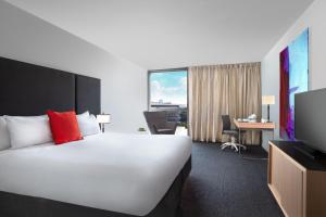 a hotel room with a large bed and a large window at Mantra South Bank Brisbane in Brisbane