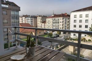 a balcony with a bench and a view of a city at Campania in Ourense