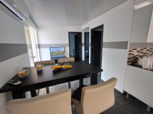 a dining room with a black table and chairs at Ferienwohnung Marlene in San Bartolomé