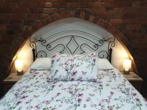 sypialnia z łóżkiem z poduszkami i 2 lampami w obiekcie Lyndene w mieście Penistone