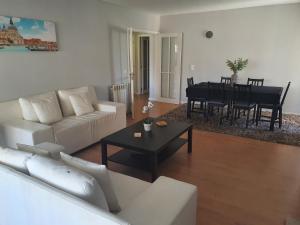 a living room with a white couch and a table at Central Bus Station Flat in Braga