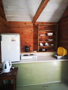 a kitchen with a stove and a white refrigerator at Hardanger Kulturgalleri in Herand +5 photos