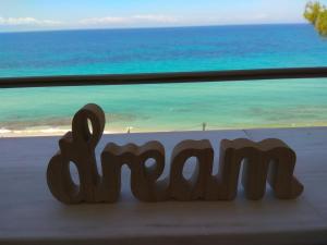 a wooden sign that says mom in front of a window at By the sea with great view luxury in Siviri